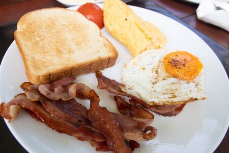 English breakfast with fried eggs,bacon and toasの写真素材