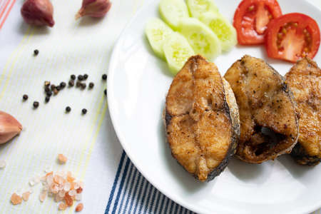 Delicious fresh king fish fried on a white plateの写真素材
