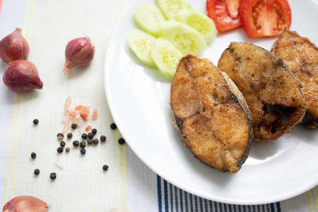 Delicious fresh king fish fried on a white plateの写真素材