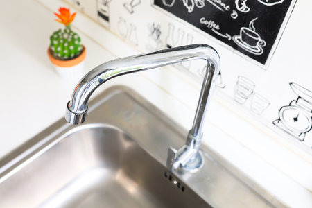 Water tap with sink in modern kitchen.