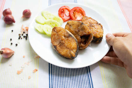 Delicious fresh king fish fried on a white plateの写真素材