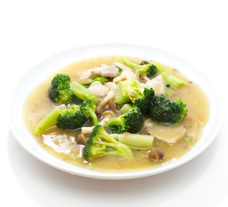 Chinese style deep fried yellow noodles with pork, chili, vegetables and soup の写真素材