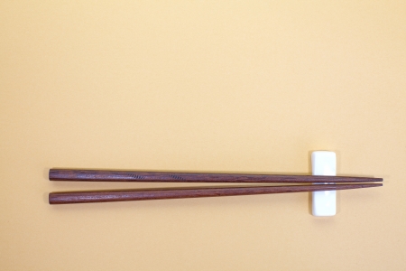 chopsticks on a brown backgroundの写真素材