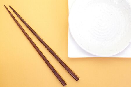 Empty white plate with chopsticksの写真素材