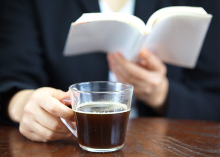 Close up of female holding mug with hot coffee