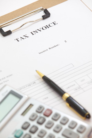 Business document of tax invoice form with pen and calculatorの写真素材