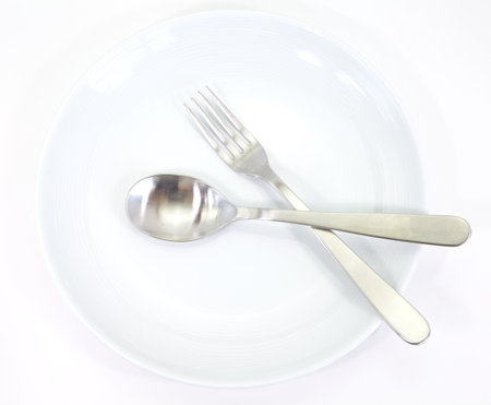 white plate with fork and spoon setting