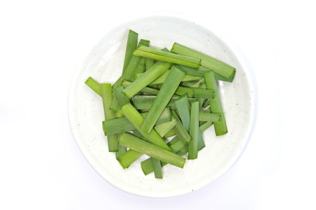 fresh green leek vegetable chopped on plateの写真素材