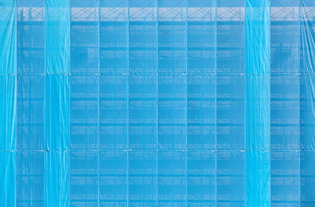 Blue plastic cover old building during renovationの写真素材