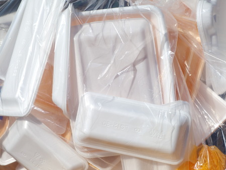 Foam food box in plastic bag ready for recycleの写真素材