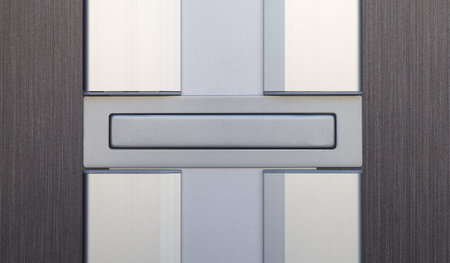 Sliver letterbox or mailbox and wood door at house