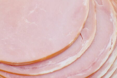 Fresh sliced roast ham isolated on white backgroundの写真素材