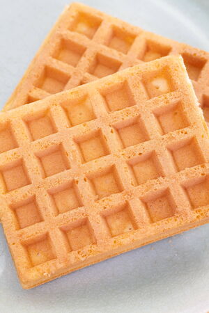 Delicious sweet waffle in ceramic plate on white plateの写真素材