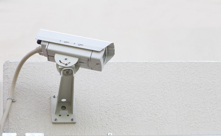 video camera security system on the wall of the buildingの写真素材