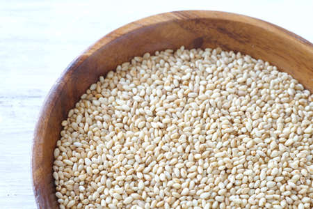 Organic natural sesame seeds on white wood tableの写真素材