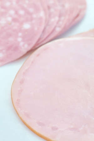 Fresh sliced roast ham isolated on white backgroundの写真素材