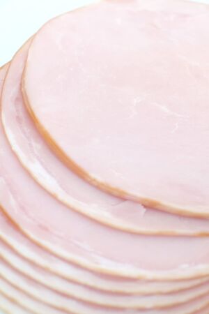 Fresh sliced roast ham isolated on white backgroundの写真素材