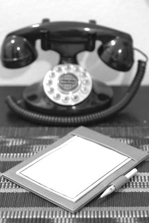 Blank white paper note and old style telephoneの写真素材