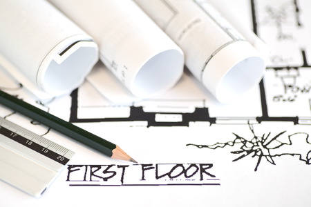 Architect rolls and plans construction project drawingの写真素材