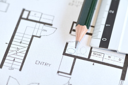 Architect rolls and plans construction project drawingの写真素材