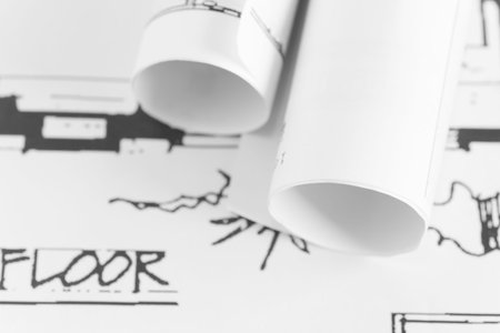 Architect rolls and plans construction project drawing