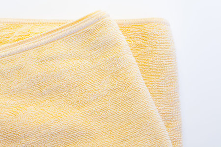 Clean yellow towel on a white background