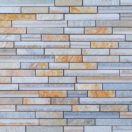 Texture and seamless background of brown granite stone block wall