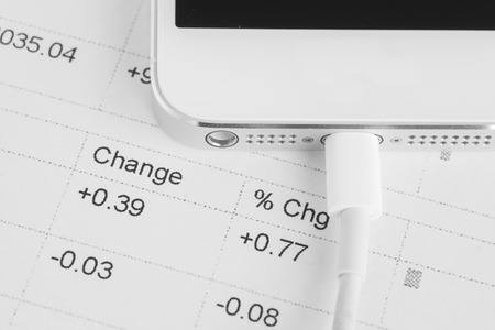 Close - up Mobile phone charging on business paperworkの写真素材