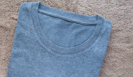 Black men t-shirt on brown towel backgroundの写真素材