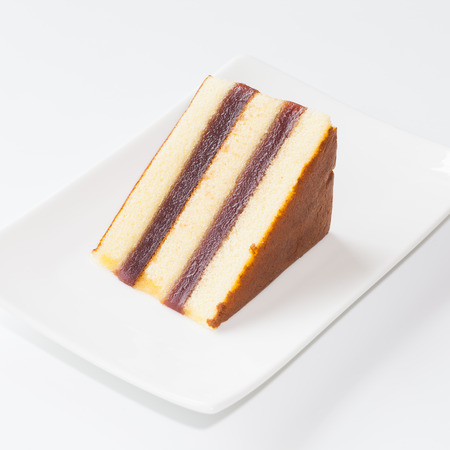 Sweet sponge cake and chocolate on white backgroundの写真素材