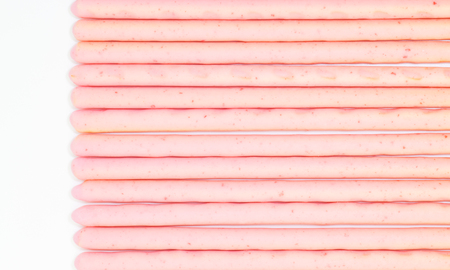 japanese snack food biscuit stick strawburry coated on white backgroundの写真素材