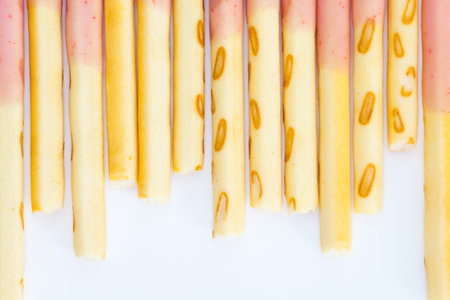 Japanese snack food biscuit stick strawburry coated on white backgroundの写真素材