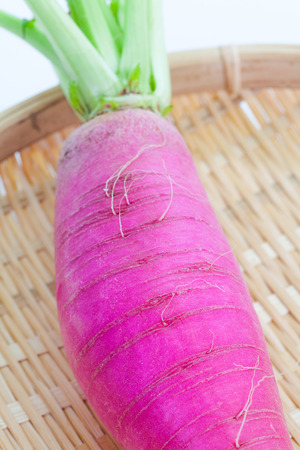 Large and fresh purple daikon radish in bamboo trayの写真素材
