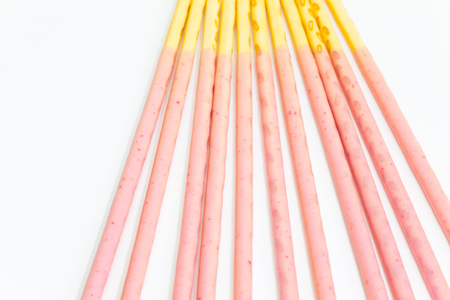 Japanese snack food biscuit stick strawburry coated on white backgroundの写真素材
