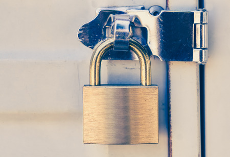 Close - up Metal padlock and metal white doorの写真素材