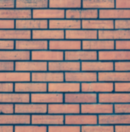 Red brick stone wall and blurred  seamless background and textureの写真素材
