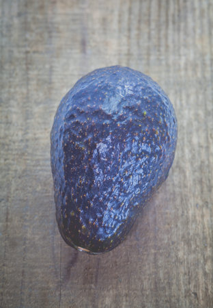 Avocado fruit on old wood table background