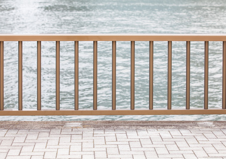 Metal fence and concrete floor at riversideの写真素材