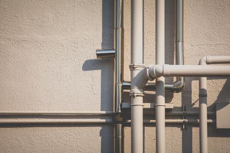 Pipeline water detail at industrial building wallの写真素材
