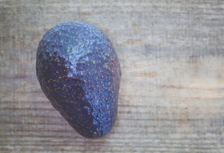 Avocado fruit on old wood table backgroundの写真素材