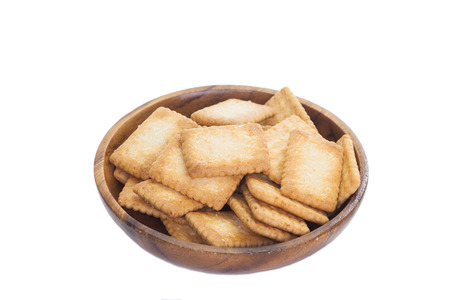 Mini coconut biscuit in wood plate isolated on white backgroundの写真素材