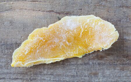 Piece of Dehydrated mango on wood table backgroundの写真素材