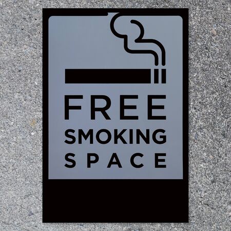 Signboard of smoking space area on concrete wall backgroundの写真素材
