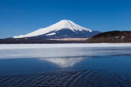 Mountain fuji and reflection on ice lake in winter season at Yamanakako lake , Yamanashi prefectureの写真素材