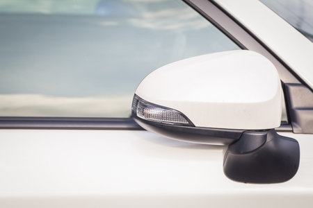 Side rear-view mirror closed for safety at car parkの写真素材