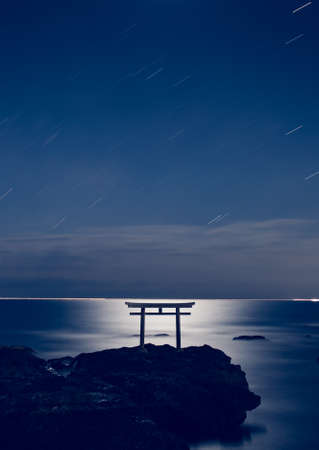 Japanese shinto gate at sea with beautiful moonlight in Oarai, Ibaraki prefectureの写真素材