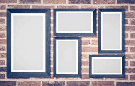 Wooden picture frame on brick wall backgroundの写真素材