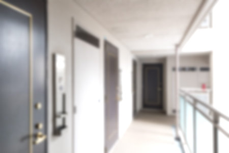 Blurred background of long corridor at apartment buiding