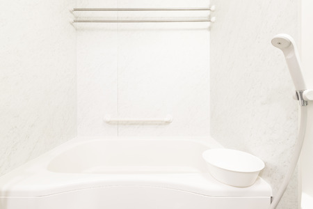 White bathtub and shower at clean bathroomの写真素材