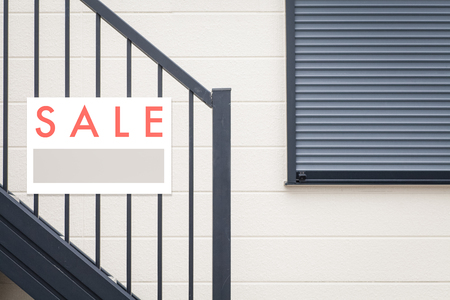 Sale Real Estate Sign in Front of houseの写真素材